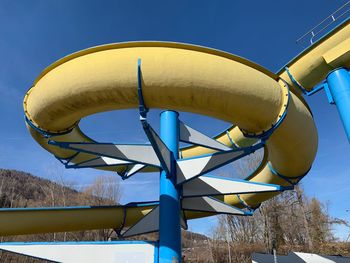 Low angle view of umbrella against clear blue sky