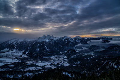 Scenic view of snowcapped mountains against sky during sunset