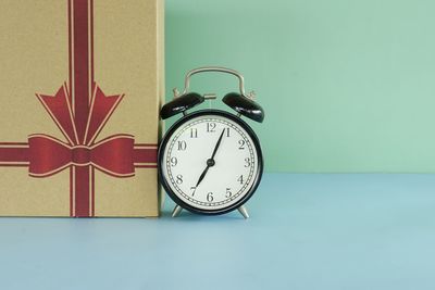 Close-up of alarm clock on table