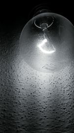 Close-up of water drops on light bulb