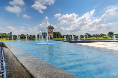 View of  pool against cloudy sky