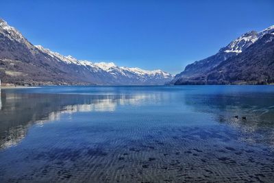 Scenic view of snowcapped mountains against cloudy sky