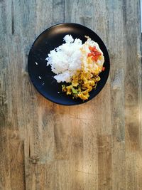 Spicy thai food, pork curry and fried egg with stream rice