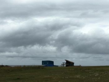 Built structure on landscape against sky