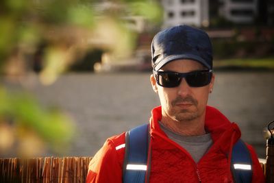 Portrait of mature man wearing sunglasses while standing outdoors