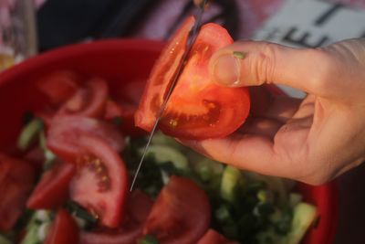 Close-up of hand holding strawberry