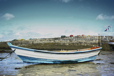 Boats moored on sea against sky