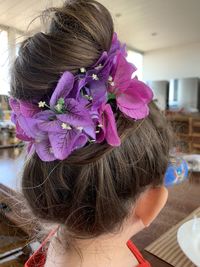 Close-up portrait of woman with purple flowers