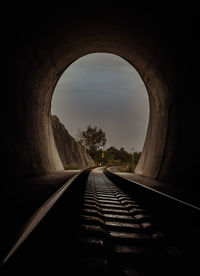 Rear view of man walking in tunnel