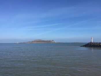 Scenic view of sea against blue sky