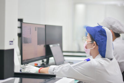 Side view of scientist working in laboratory