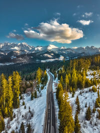 Scenic view of snowcapped mountains against sky during winter