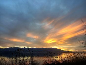 Scenic view of snowcapped mountains against sky during sunset