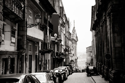 People walking on street amidst buildings in city