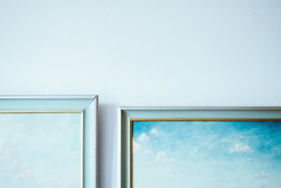 Cropped image of paintings on wall