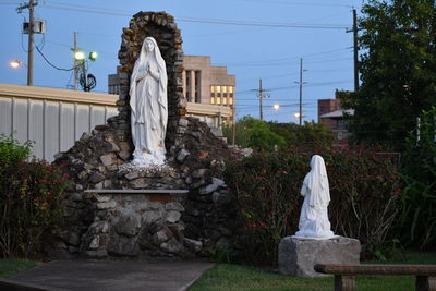 Statue against trees and plants