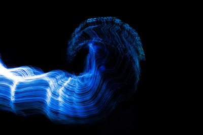 Abstract light painting against black background