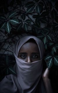 Close-up portrait of young woman wearing scarf