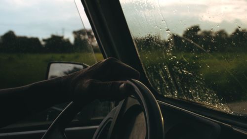 Man seen through car window