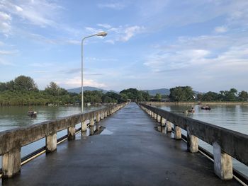 Pier over river against sky