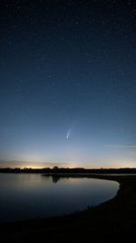 Scenic view of lake against sky at night neowise comet