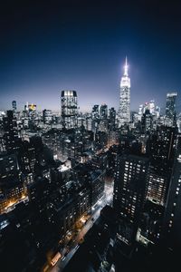 Aerial view of city lit up at night