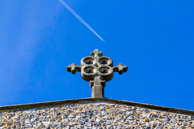 Low angle view of cross against clear blue sky