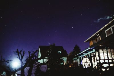 Low angle view of trees against sky at night