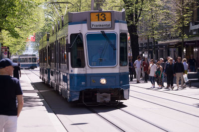 People on railroad tracks in city