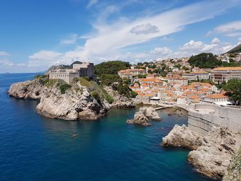 Townscape by sea against sky