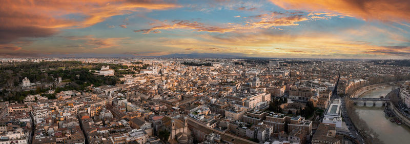 Aerial view of cityscape against sky during sunset