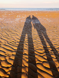 Shadow of people on beach