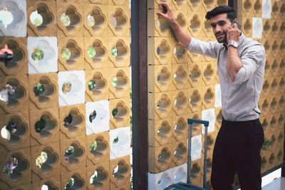 Full length of man standing against wall