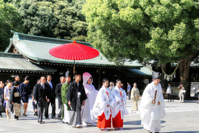 People in traditional clothing standing outdoors