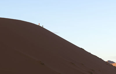 Low angle view of horse on desert against clear sky