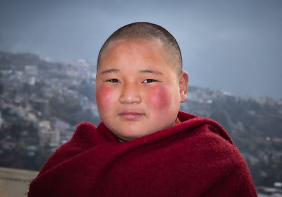 Teen buddhist monk portraits close up with details at day from flat angle