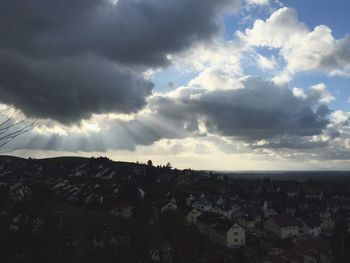 Cityscape against cloudy sky