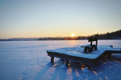 Scenic view of frozen lake against clear sky during winter