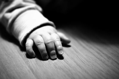 Close-up of baby hand on table