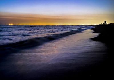 Scenic view of beach against sky during sunset