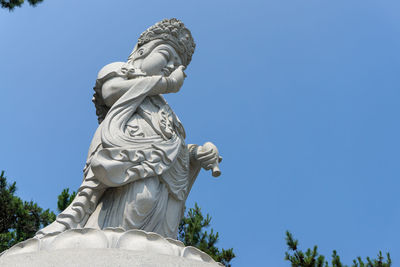 Low angle view of statue against sky