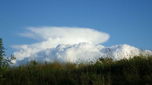 Scenic view of mountains against cloudy sky