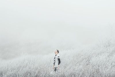 Young man standing on field