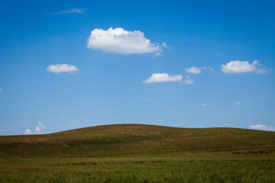 Scenic view of landscape against blue sky