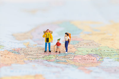 Miniature backpacker on map, concept of travel around the world and the adventure.