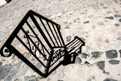 High angle view of empty chair against wall