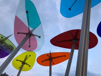 Low angle view of coloured art sculpture against sky