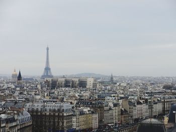 Eiffel tower in city against sky
