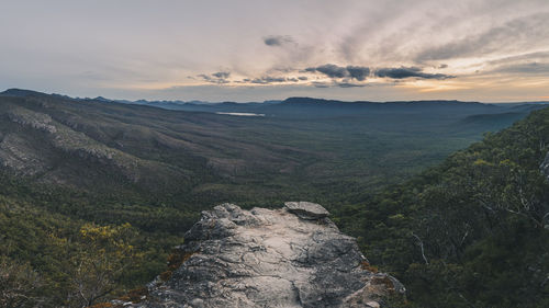 Sunset over the grampians misty valley and lush forest from the top of a view point, victoria, australia