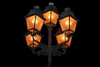 Low angle view of illuminated lamp at night